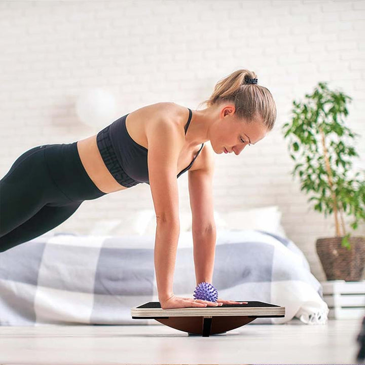 Planche d'équilibre en bois naturel pour exercices de fitness, renforçant force et équilibre corporel.