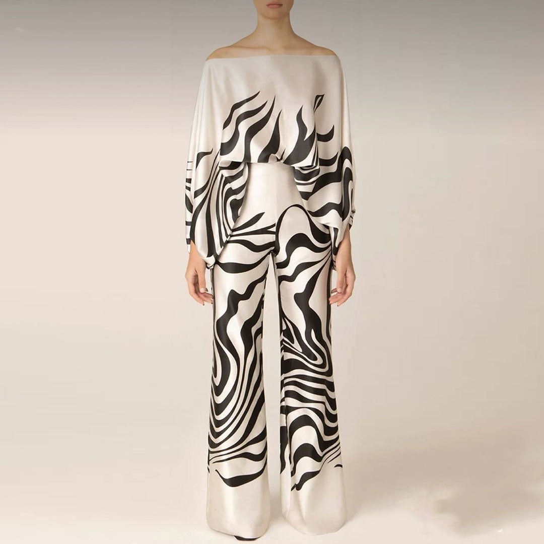 Ensemble femme deux pièces élégant : top épaules dénudées et pantalon large taille haute, parfait pour soirée chic.