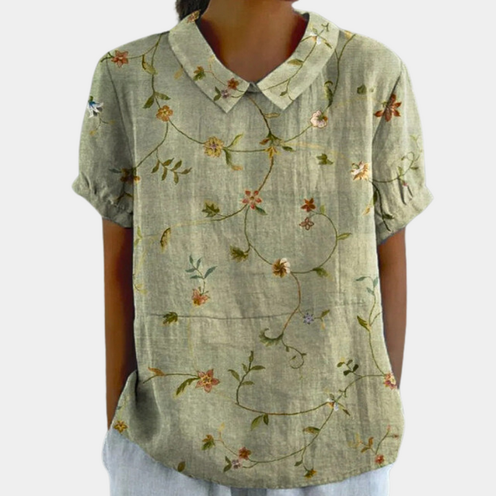 Top femme mode, blouse fleurie printemps-été à manches courtes, motif pastoral délicat.