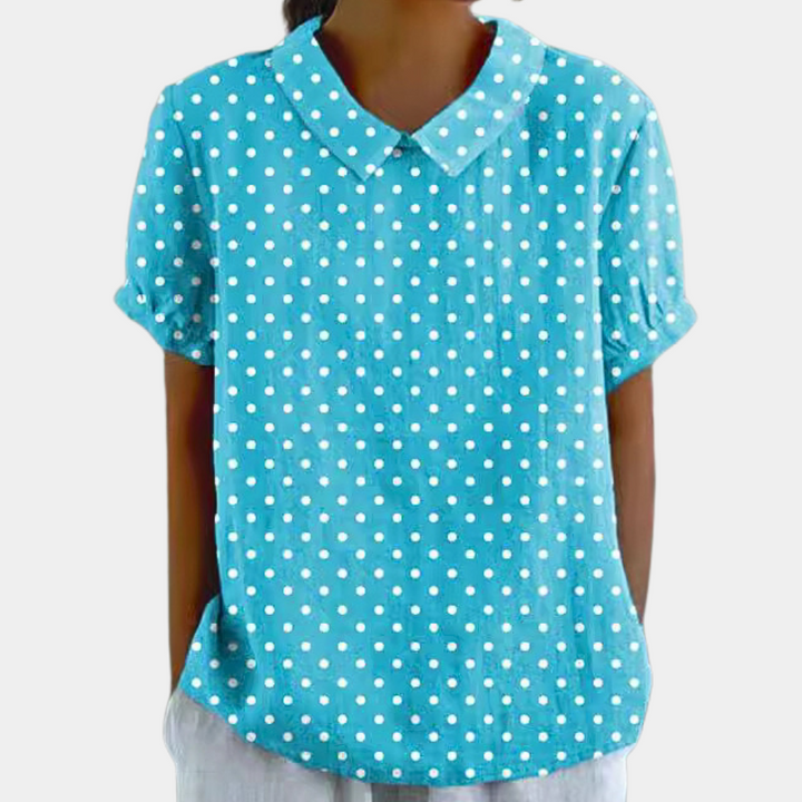 Blouse femme à col rond, motifs floraux, manches courtes, parfaite pour un style élégant.