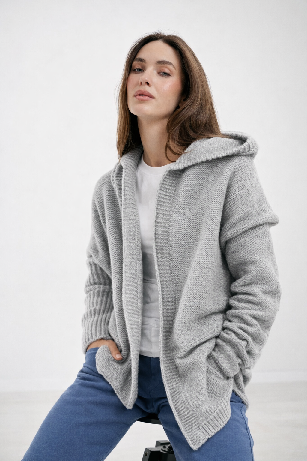Femme portant un cardigan oversize élégant à capuche, doux et confortable, parfait pour l'automne et l'hiver.