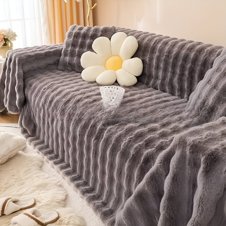 Plaid polaire pour canapé, synonyme de détente, de chaleur et d'une touche déco tendance.