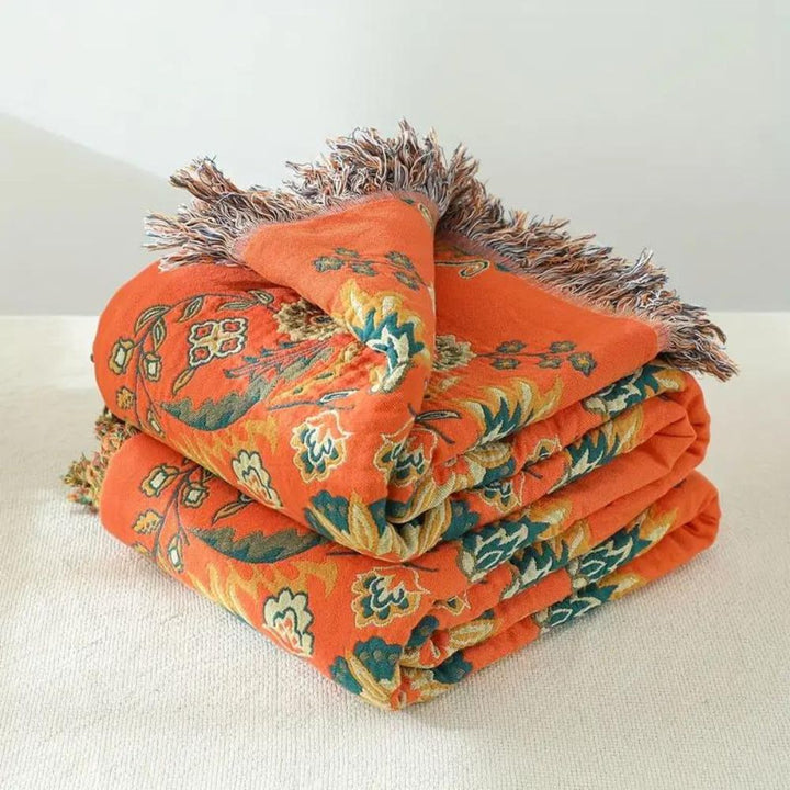 Jeté de canapé floral réversible orange et bleu sarcelle, couverture légère en coton, idéale pour une ambiance maison.