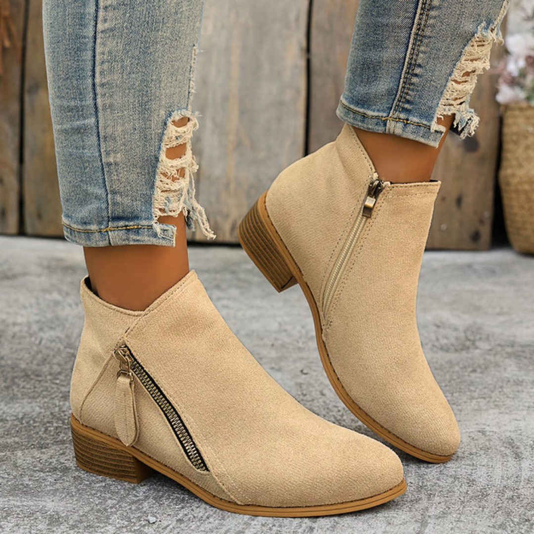 Bottines noires femme, élégantes et confortables, avec fermeture éclair et soutien plantaire.