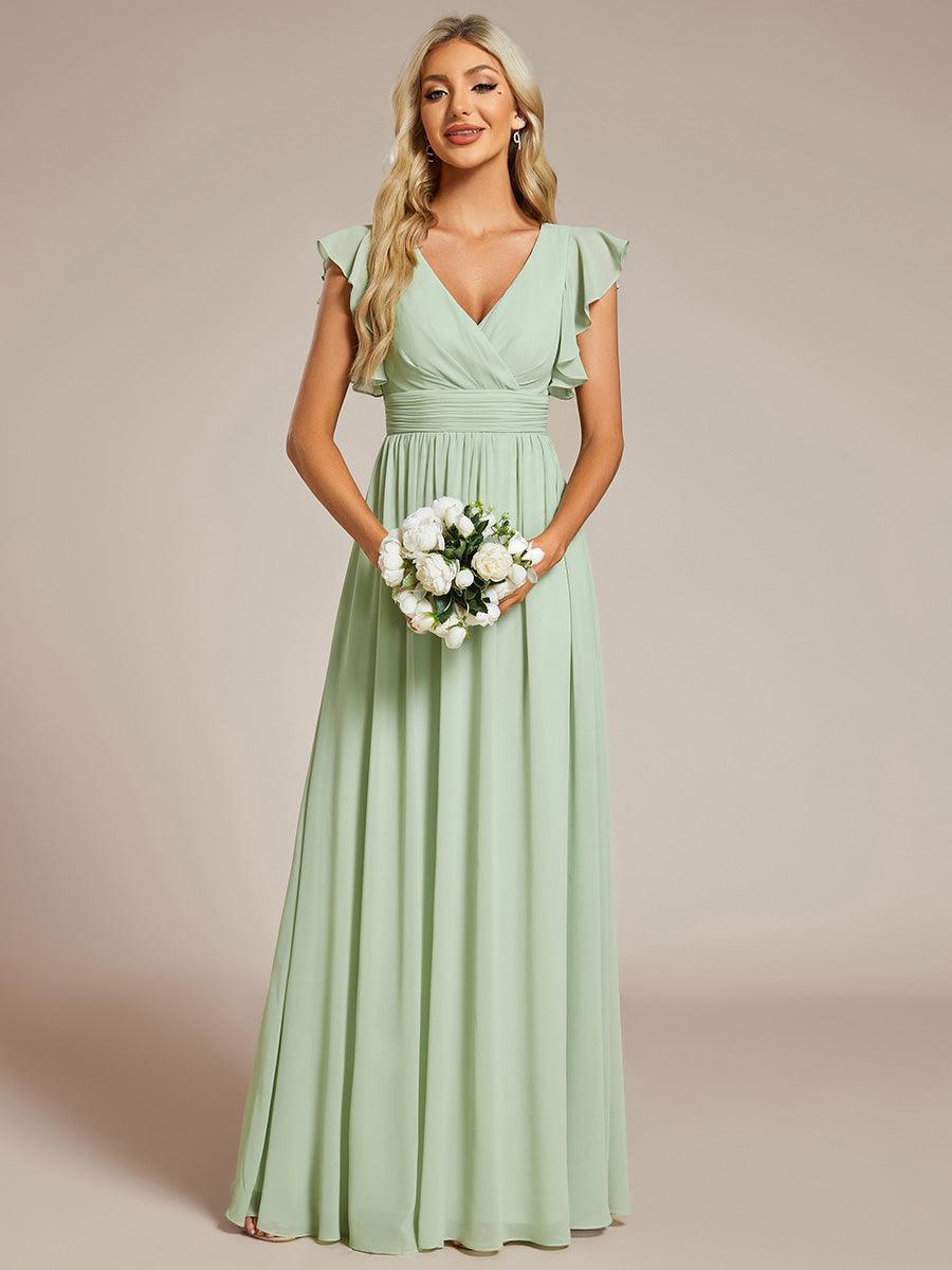 Robe de fête femme, dos ouvert, manches courtes. Parfaite pour une célébration printanière chic.