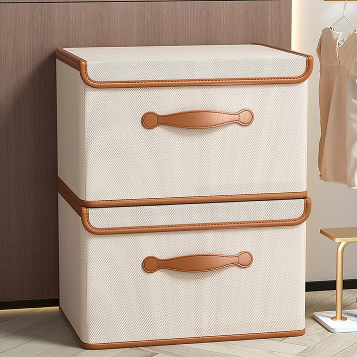 Organiseur élégant pour maison : boîte de rangement pliable en tissu avec poignées cuir, gain de place.