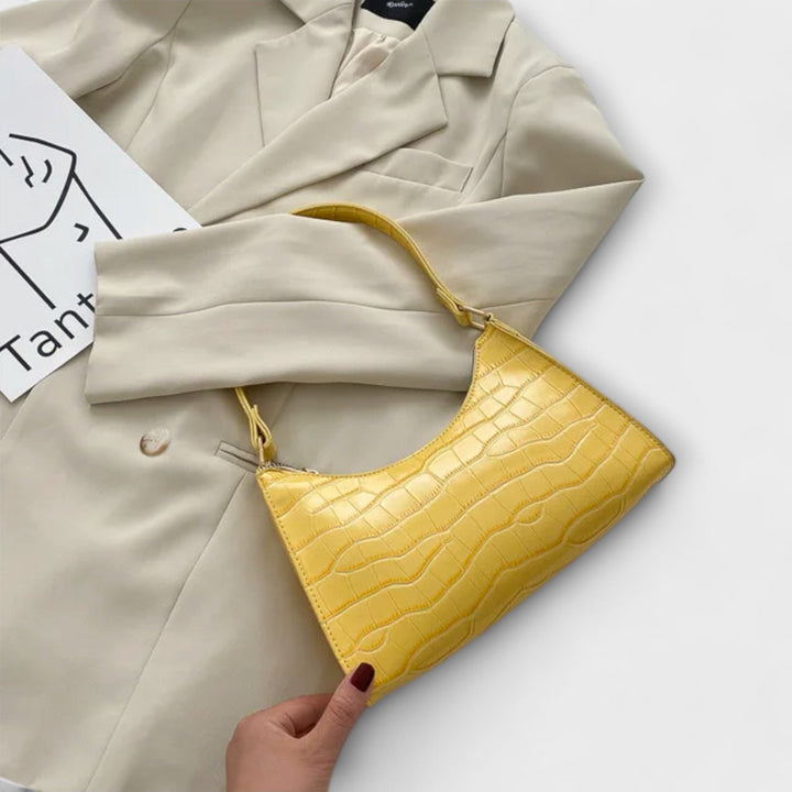Sac femme rose en cuir brillant, accessoire chic et raffiné, symbole de mode et d'élégance.