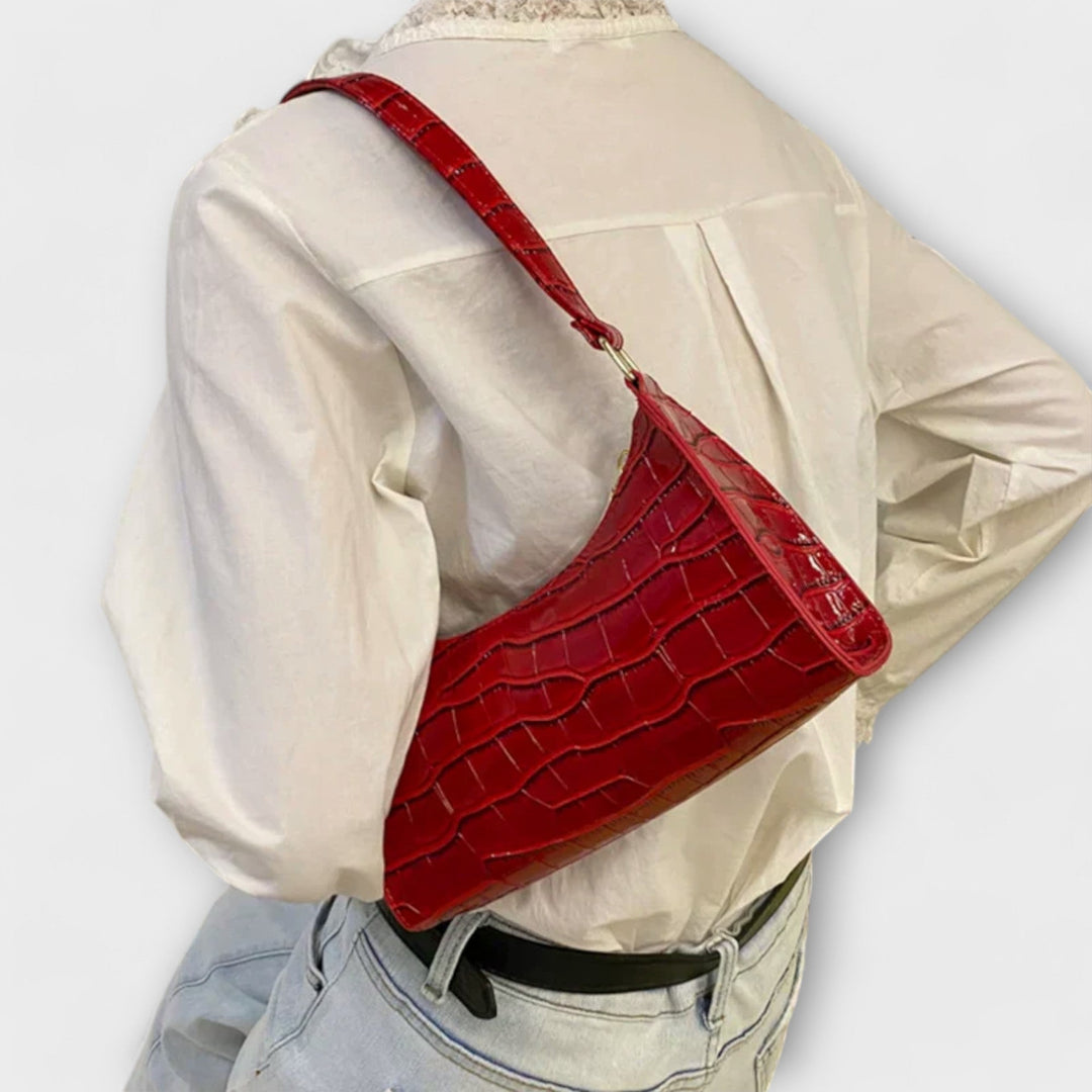 Sac à main femme jaune en cuir brillant, accessoire mode élégant et distinctif.