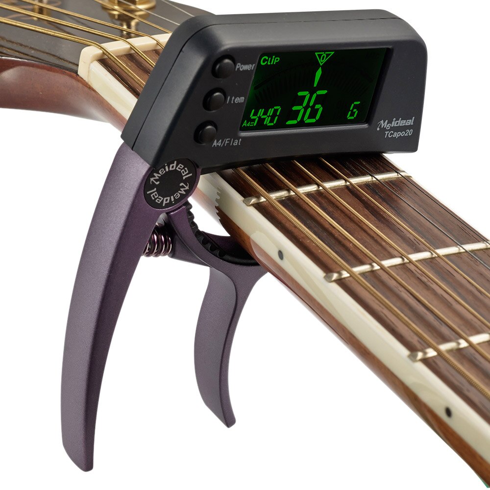 Capo guitare et accordeur numérique portable TuneGrip. Design compact et robuste pour tous les musiciens.