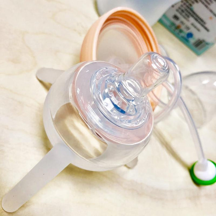 Biberon mains-libres innovant pour bébé, permettant une alimentation facile et une parentalité sereine.