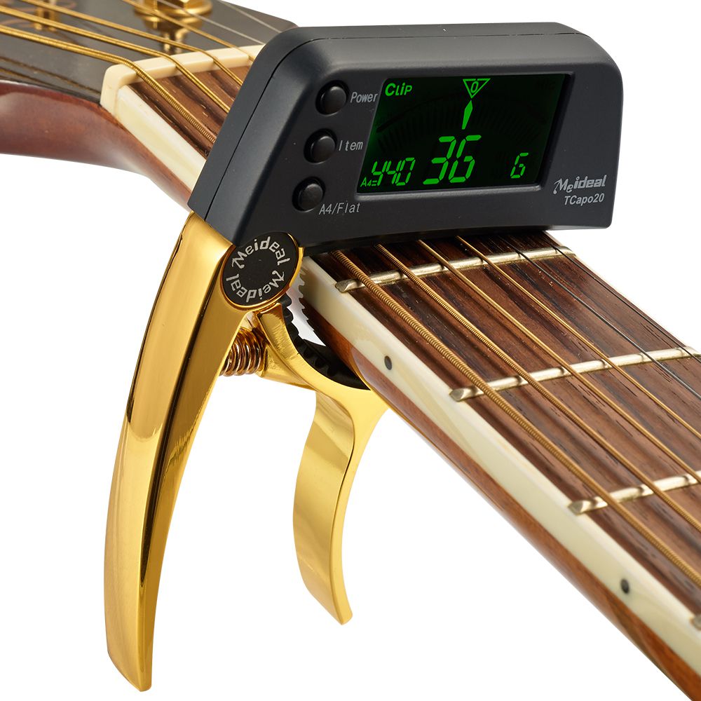 Capo polyvalent et accordeur précis 2-en-1 pour guitare, basse, ukulele. Performance musicale améliorée.