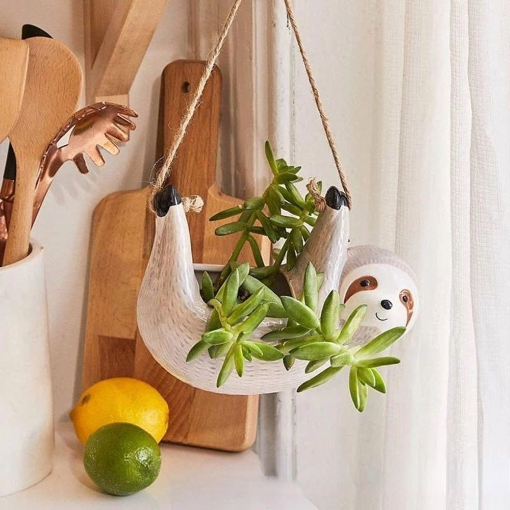Pot de fleurs en céramique gris avec design paresseux, parfait pour plantes d'intérieur.