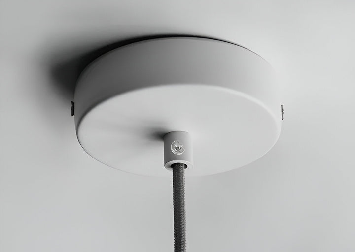 Lampe suspendue design macaron jaune, pour une touche nordique au salon.