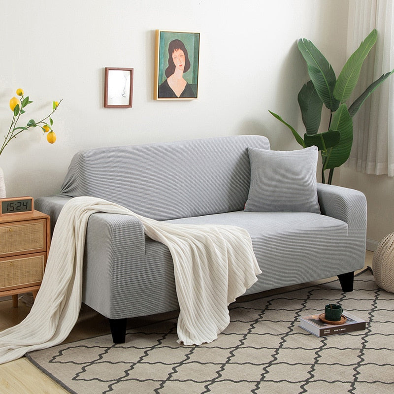 Rénovation meuble: housse canapé extensible jacquard, protection efficace et élégante.