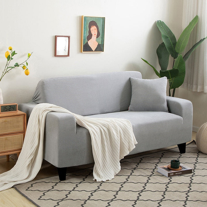 Rénovation meuble: housse canapé extensible jacquard, protection efficace et élégante.