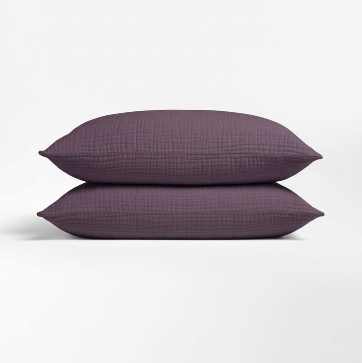 Taies d'oreiller ultra douces en mousseline de coton, essentielles pour un linge de lit de qualité supérieure.