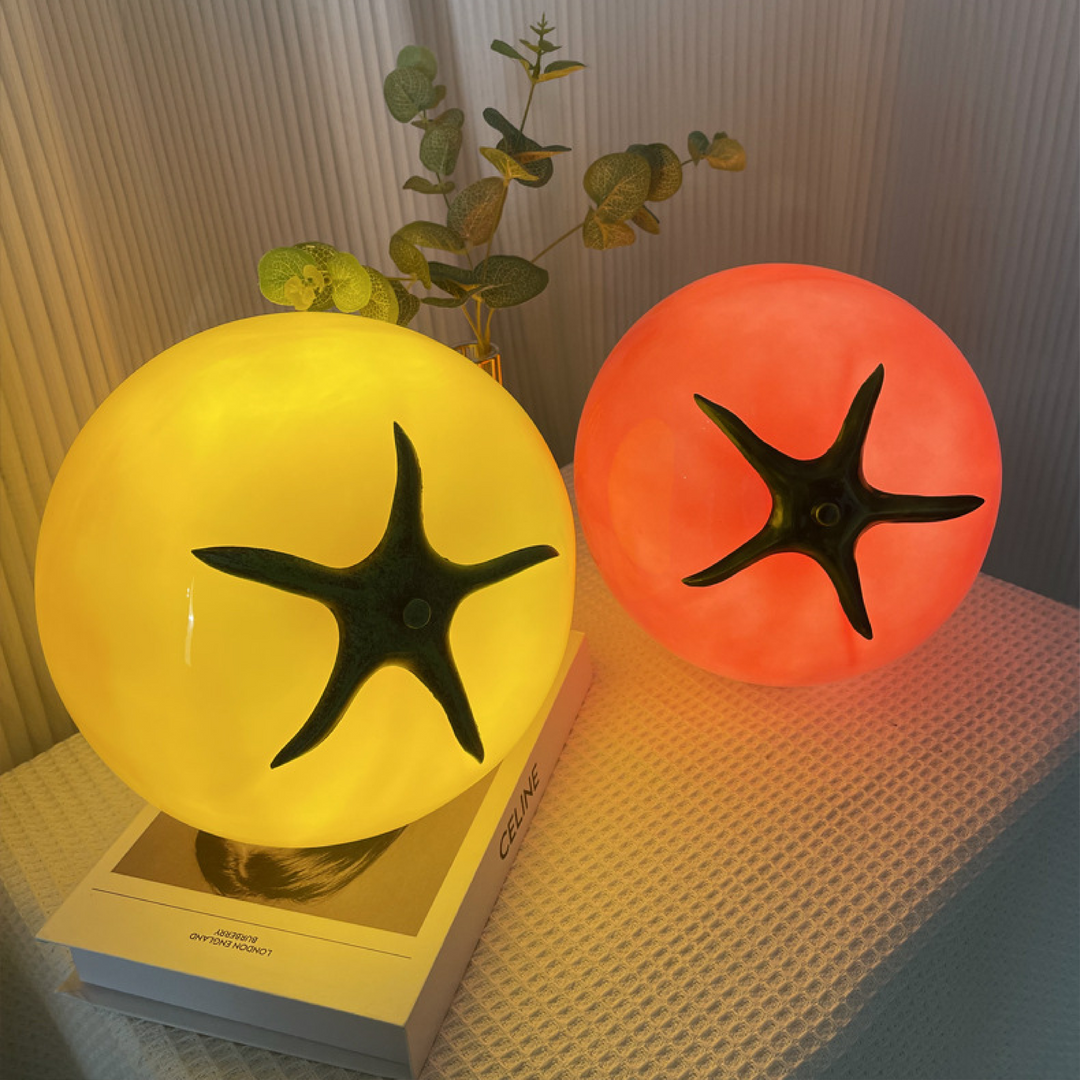 Lampe d'appoint moderne en forme de tomate, diffusant une lumière chaude et accueillante.