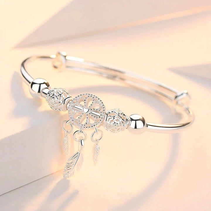 Bijou ajustable en argent 925 pour femme, motif attrape-rêves avec plume délicate.