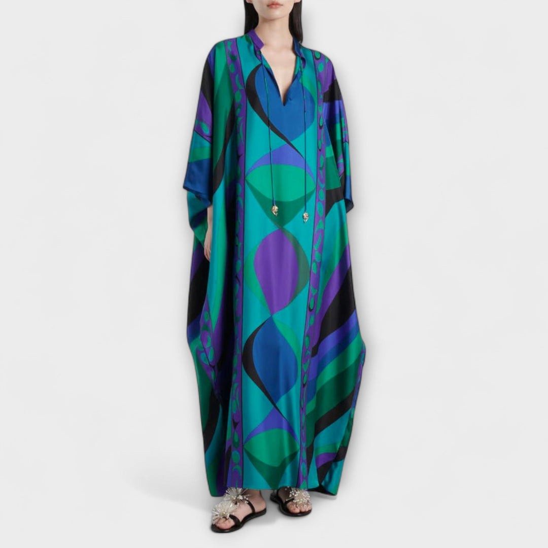 Kaftan femme en satin fluide et léger, motif psychédélique éclatant. Robe élégante pour l'été et les vacances.