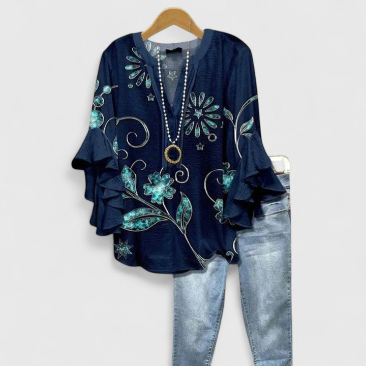 Blouse femme élégante à design floral, coupe moderne et fluide, parfaite pour un look printanier.