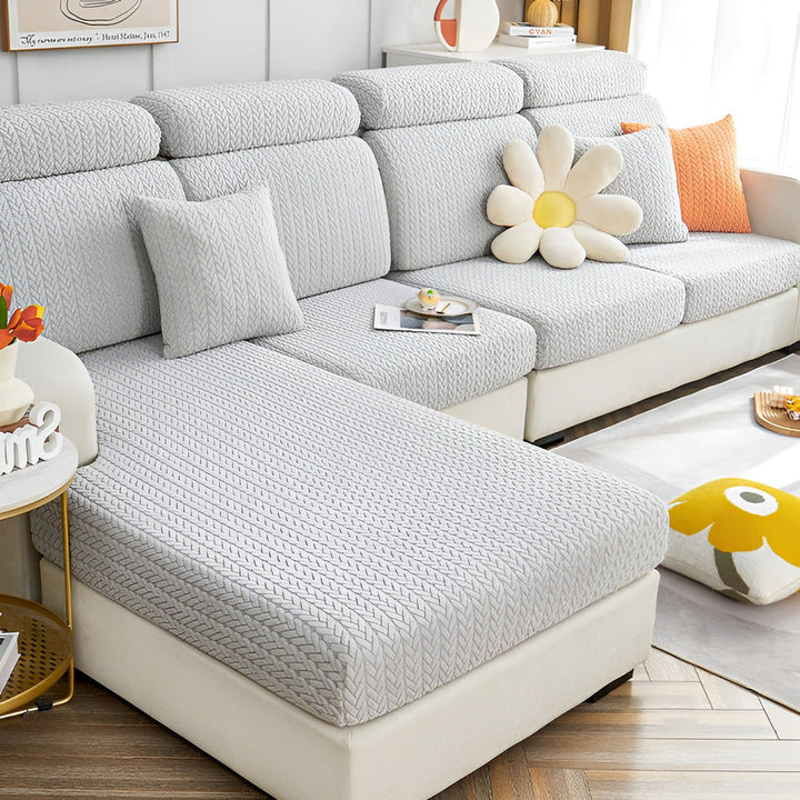 Couvre-canapé jacquard extensible anti-taches, idéal pour familles et animaux de compagnie.