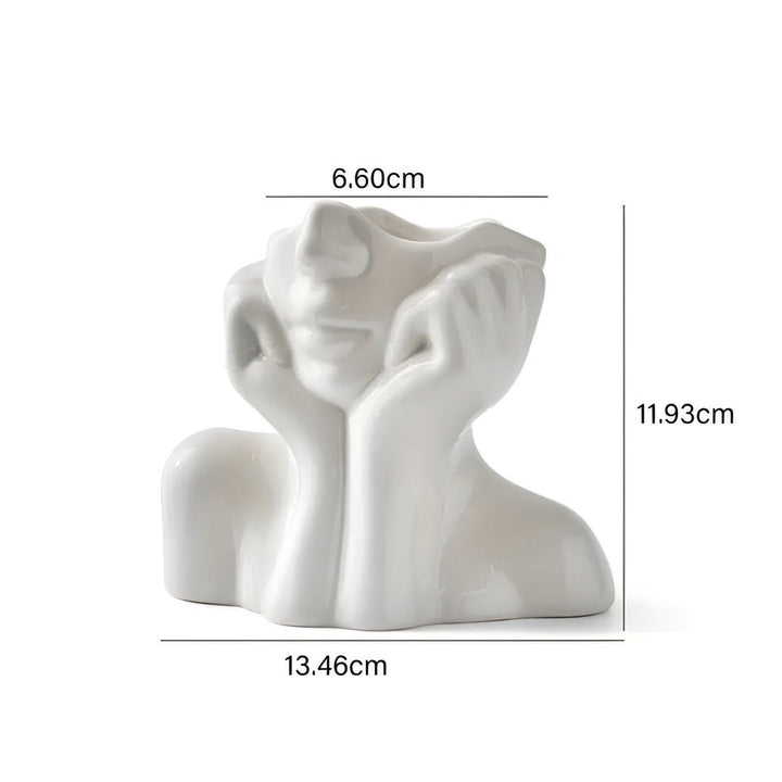 Vase décoratif artistique, visage expressif, met en valeur la beauté des fleurs et du design moderne.