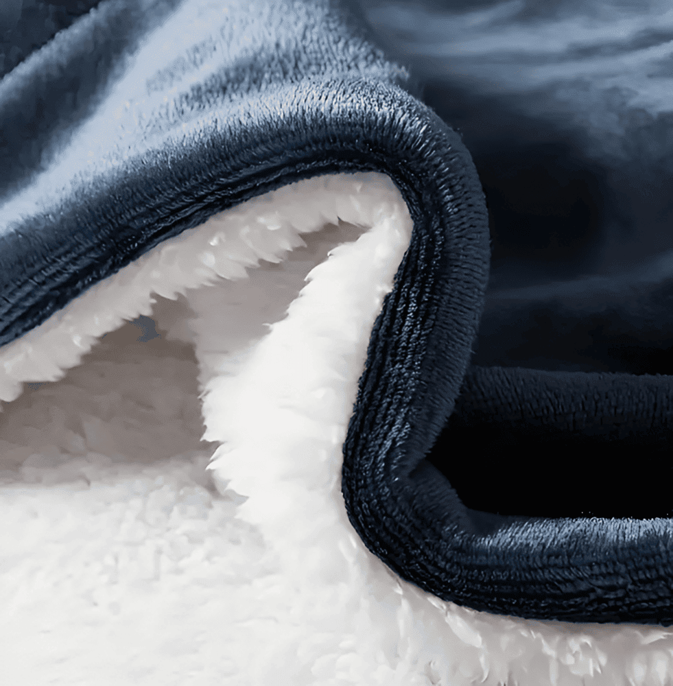 Plaid réversible polyester, face polaire et face Sherpa. Couverture douillette, chaude et moelleuse pour un hiver confortable.