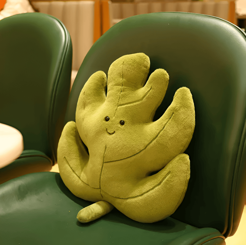Coussin velours feuille, décoratif et confortable, parfait pour un coin lecture ou une chambre.
