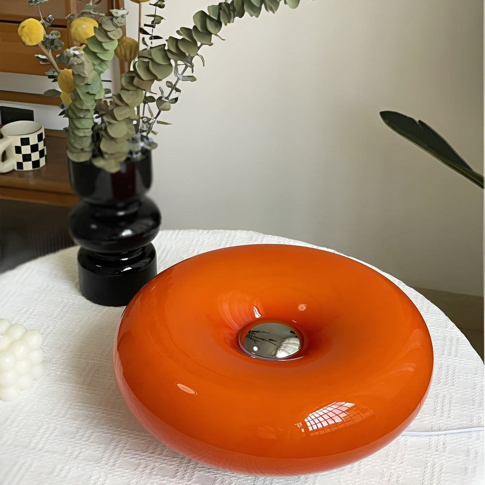 Lampe Donut design contemporain, verre orange, pour décoration murale ou de table.
