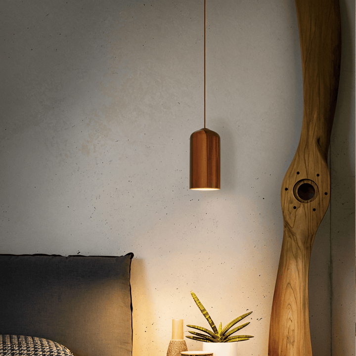 Plafonnier suspension cylindrique pour cuisine ou salle à manger, offrant une lumière chaude et accueillante.