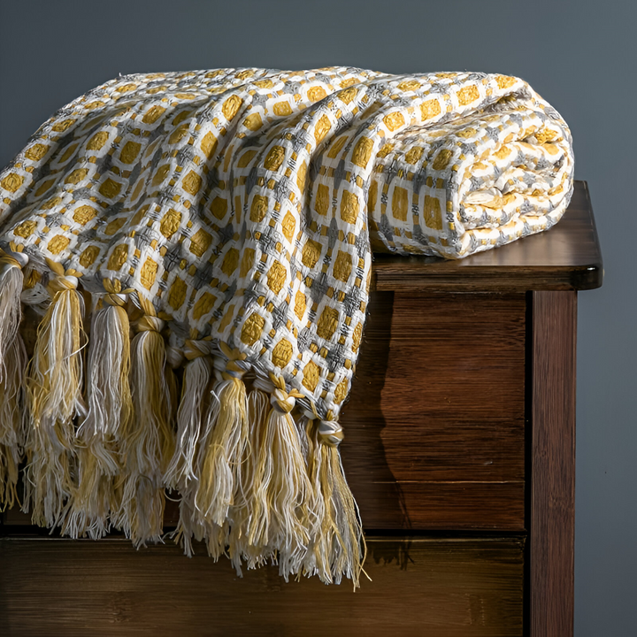 Plaid polyester léger et doux, design vintage avec franges, excellent pour le salon ou la chambre.