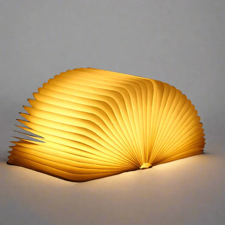 Lampe livre sans fil StoryGlow, pliable et rechargeable, parfaite pour voyager et lire partout.