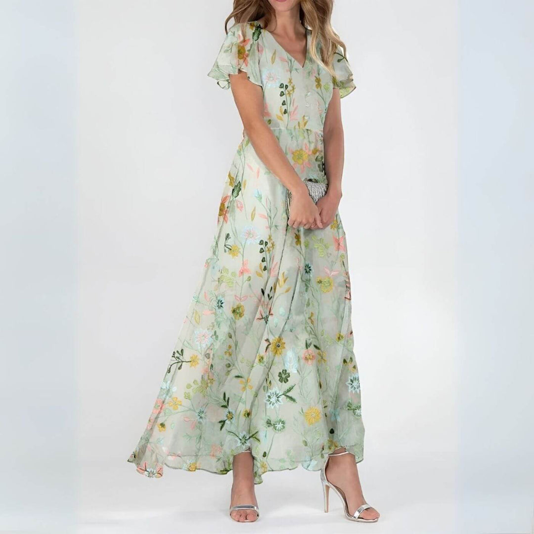 Robe fluide maxi fleurie élégante, décolleté V. Style romantique chic pour femme, parfaite pour l'été et les vacances.