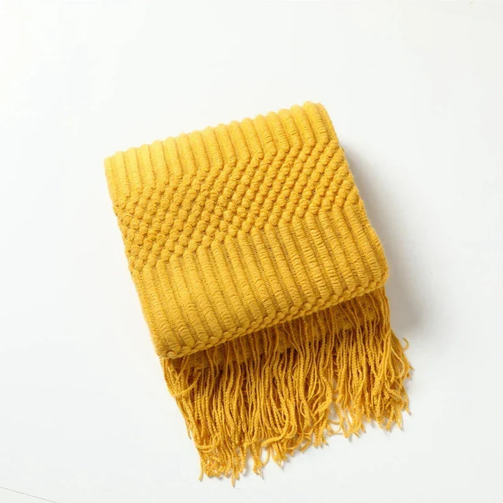 Couverture douillette tricot bohème, parfaite pour des soirées cocooning sur le canapé ou au lit.