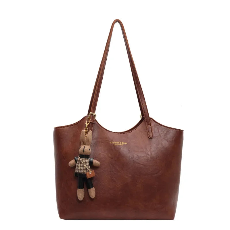 Sac à main noir pour femme en cuir végan, fourre-tout rétro. Accessoire vintage chic.