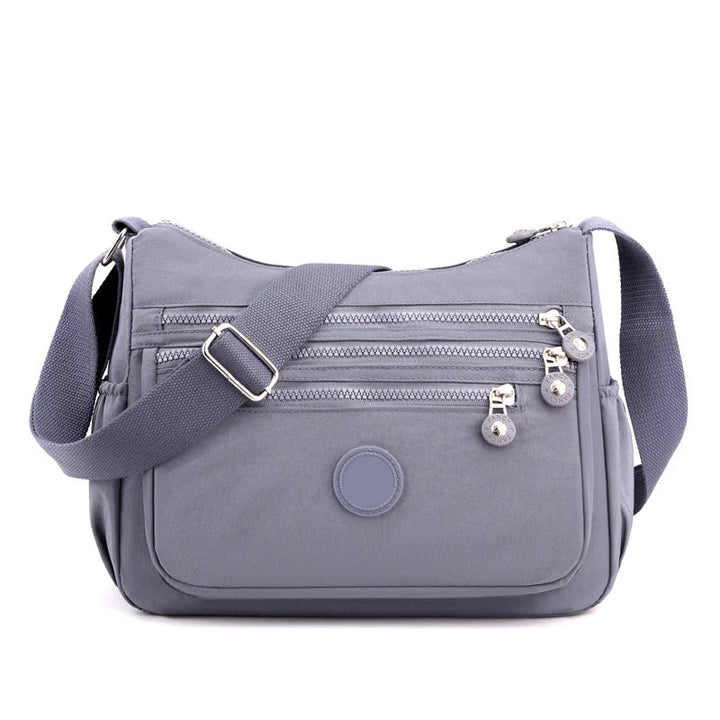 Sac bandoulière multifonction femme, nylon léger, parfait pour le voyage et l'usage quotidien.