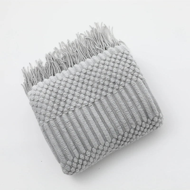 Jeté de canapé tricoté motif bohème, transformant l'espace avec chaleur et une touche de style unique.
