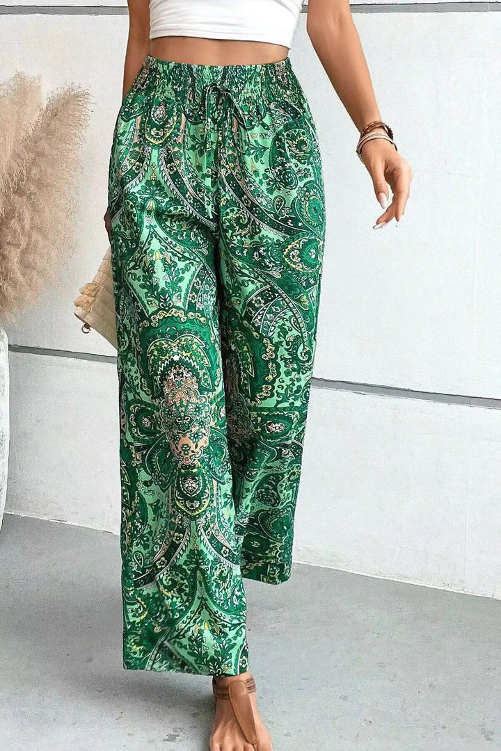 Pantalon femme large à motif vintage, taille haute et fluide, offrant confort et style pour l'été et le printemps.