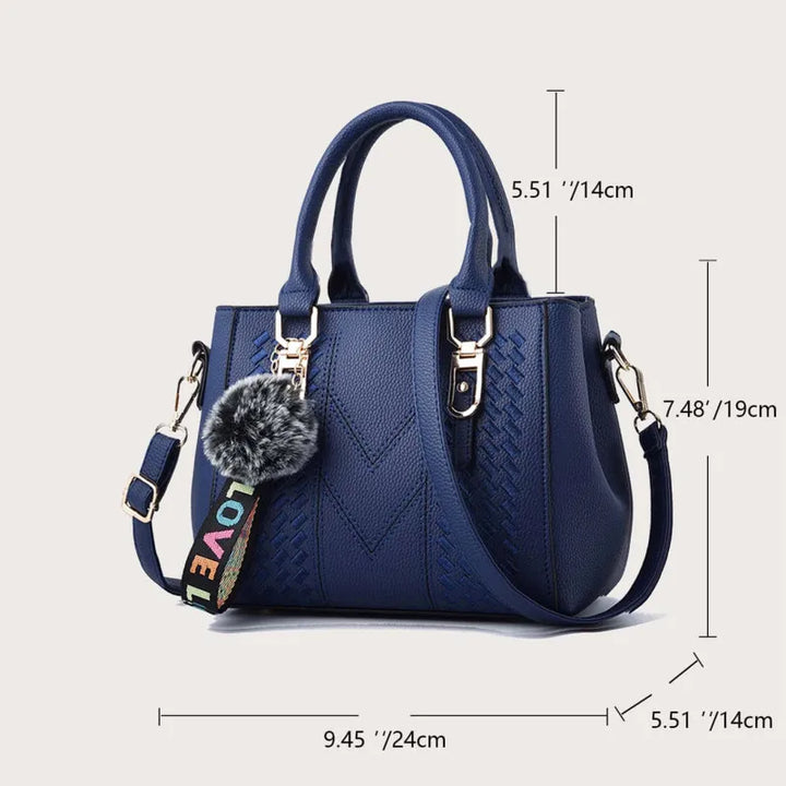 Sac à épaule chic en cuir brodé pour femme, détails fins et pompon. Idéal pour une touche d'élégance quotidienne.