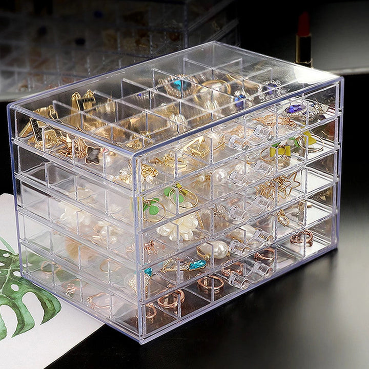 Présentoir à bijoux transparent en acrylique multiniveaux, idéal pour organiser colliers, bagues et boucles d'oreilles.