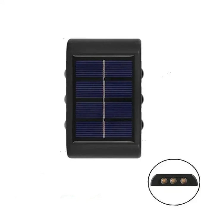 Installation d'une applique murale solaire LED bidirectionnelle sur un mur extérieur, pour un éclairage de jardin facile.
