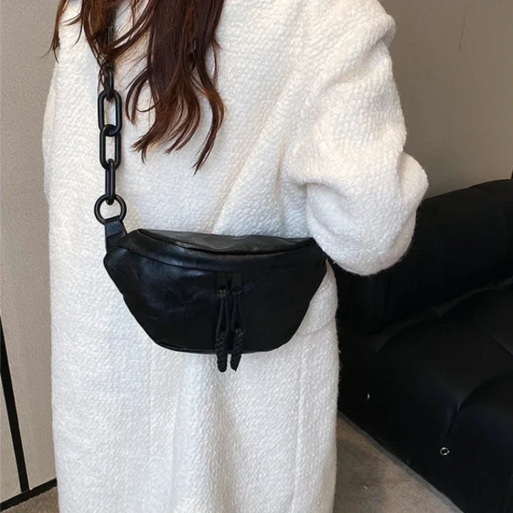 Femme stylée portant un sac banane en similicuir élégant, accessoire de mode vintage chic et pratique.