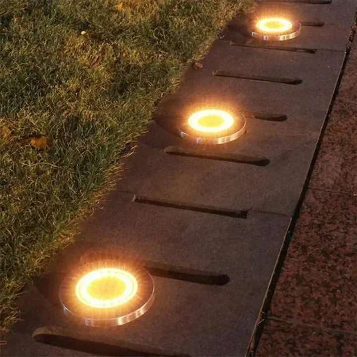 Lampe solaire de sol LED ronde en acier inoxydable, idéale pour éclairage de jardin, chemin et extérieur. Étanche.