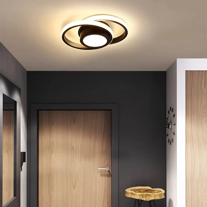 Plafonnier design LED à deux anneaux, luminaire moderne pour une ambiance lumineuse.