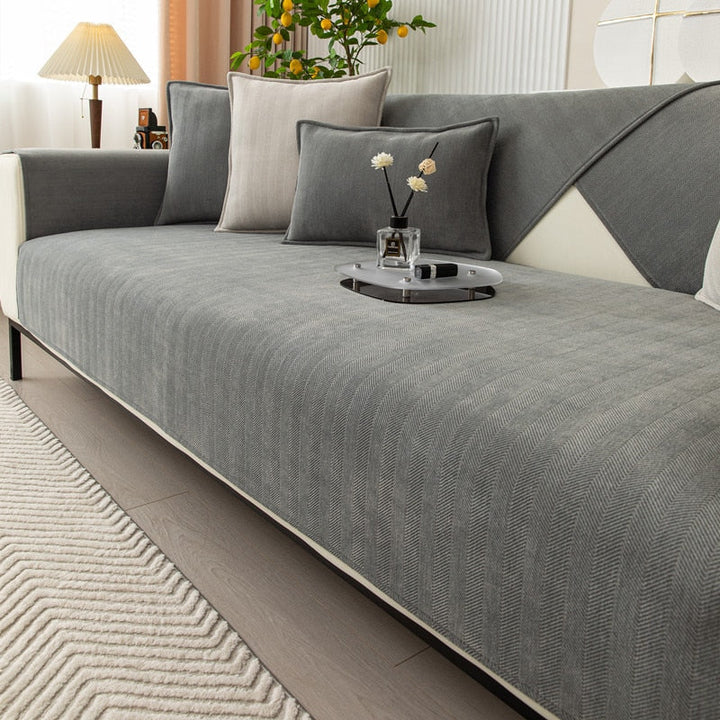 Protection efficace pour canapé avec housse extensible en textile, idéale pour préserver votre meuble de salon.