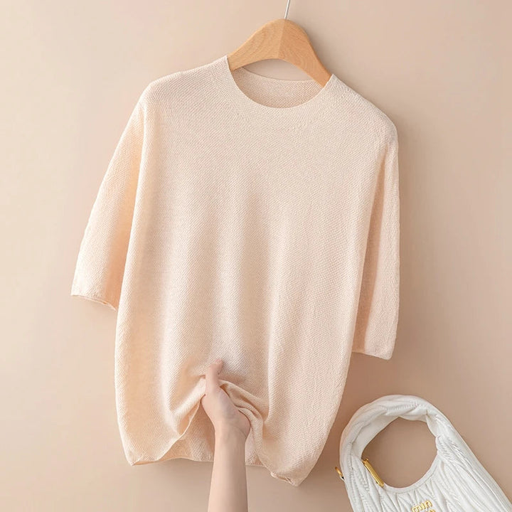 Top femme mode, pull rose à manches courtes, col rond. Vêtement élégant et confortable pour toutes occasions.