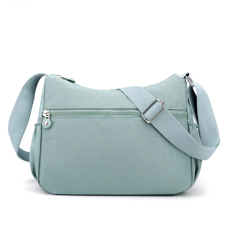 Sac bandoulière multifonction pour femme, en nylon robuste, idéal pour l'organisation et le voyage.