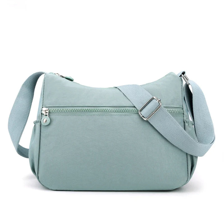 Sac bandoulière multifonction pour femme, en nylon robuste, idéal pour l'organisation et le voyage.