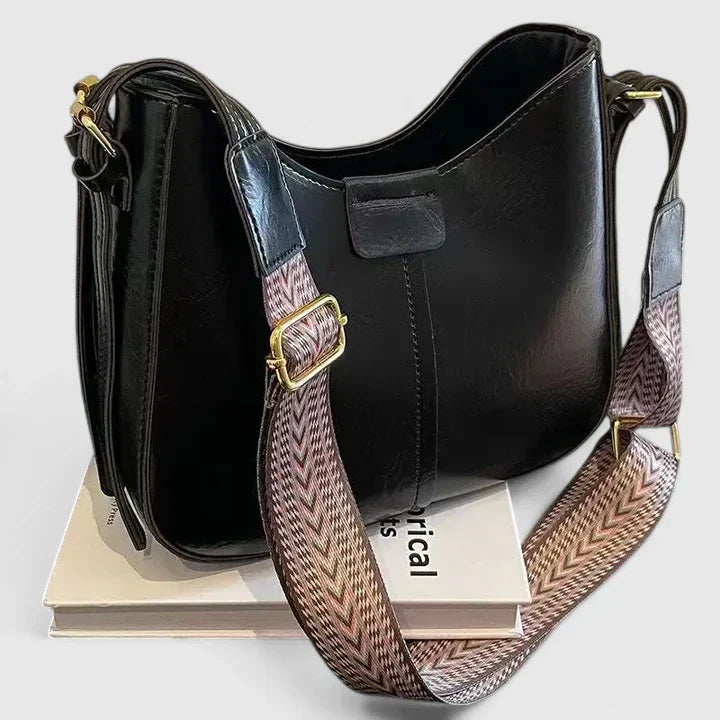 Sac à main femme chic et polyvalent avec bandoulière, accessoire de mode pour un look soigné.