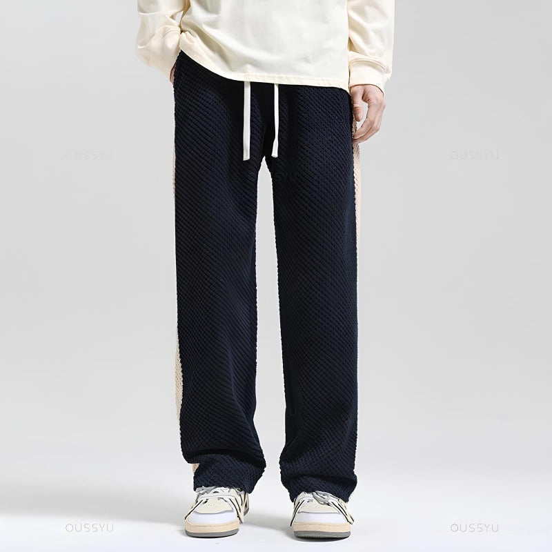 Pantalon de jogging homme léger en tissu respirant, disponible en gris et noir, pour un confort maximal.